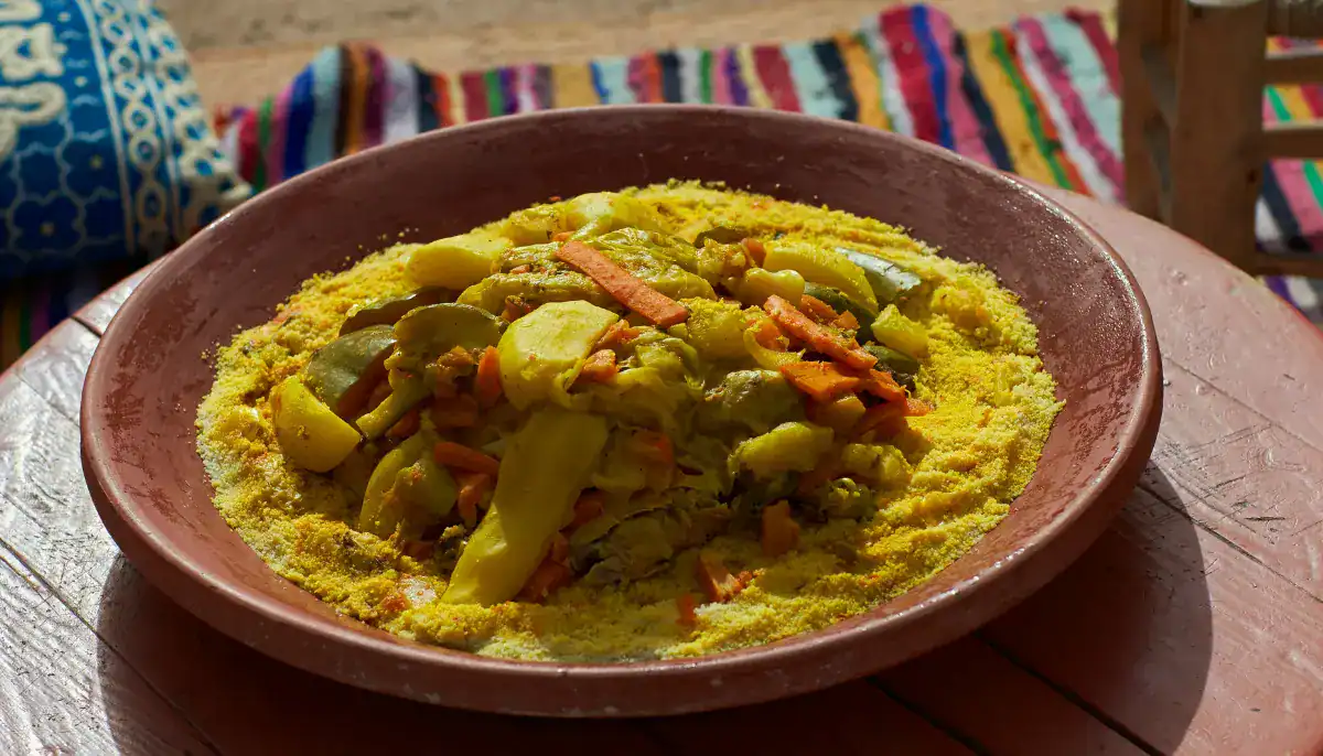 Moroccan family sharing couscous around a communal plate on Friday