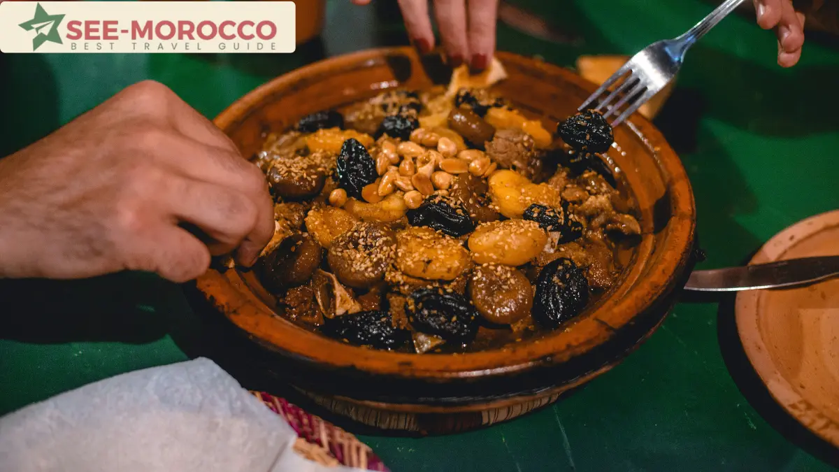 Traditional Moroccan tagine with prunes and almonds shared between two people