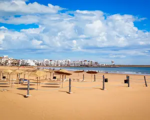 Agadir Morocco beach with sun umbrellas and resort hotels