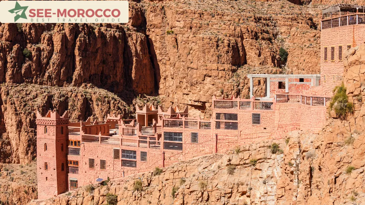 Pink guesthouse built into the canyon wall of the Dades Gorge Morocco