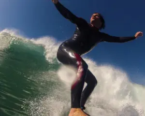 Surfer in Morocco riding green Atlantic wave close-up wetsuit