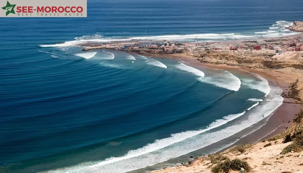 Surfing Morocco — Imsouane bay aerial view showing long peeling wave and village