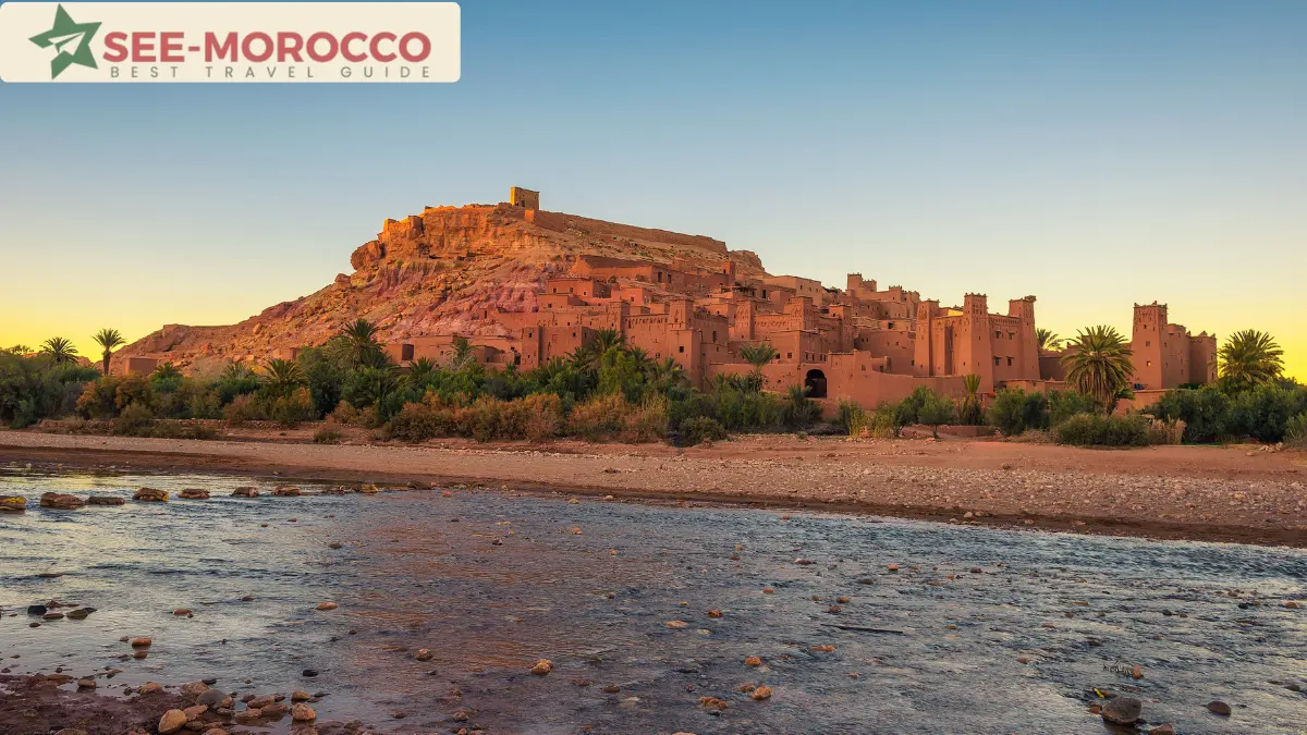 Alt: Ait Benhaddou glowing at sunset reflected in the river Morocco