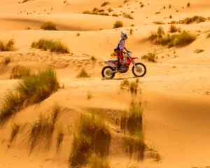 Solo rider crossing the desert dunes safely near Ouarzazate Morocco