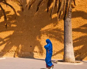 Is Morocco safe — Moroccan woman in traditional djellaba walking safely in city