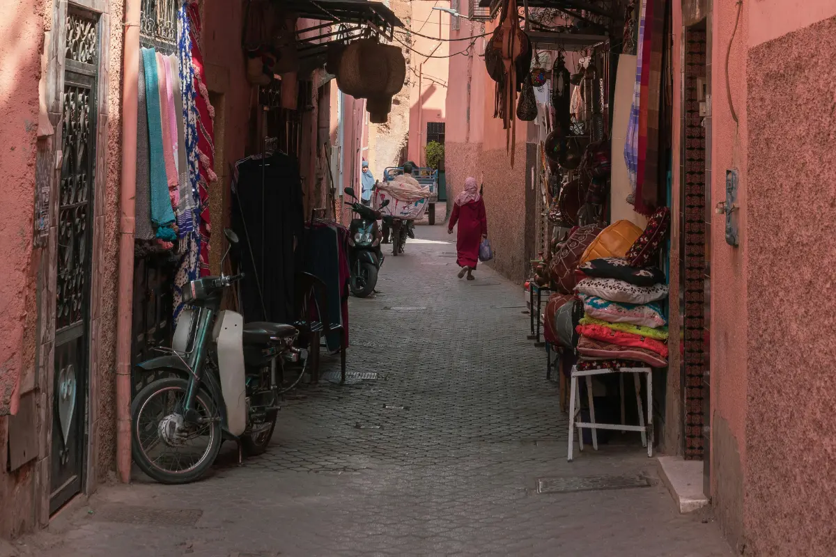 Morocco safety — narrow alley in Marrakech pink medina with shops