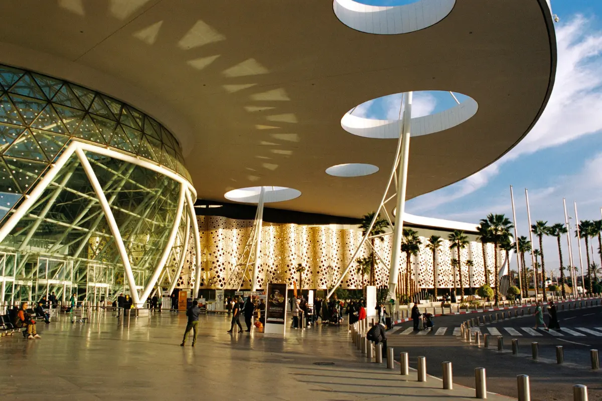 Morocco airport transfers — Marrakech Menara airport modern terminal exterior with palm trees