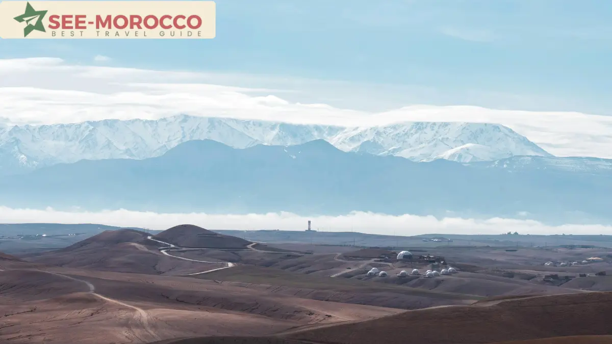Agafay Desert Morocco — rocky stone hills with snow-capped Atlas Mountains behind