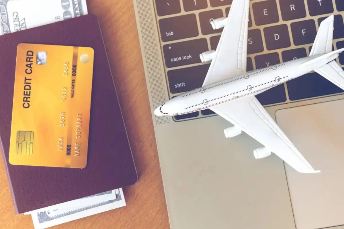 Booking flights to Morocco — passport, credit card and airplane model for online booking