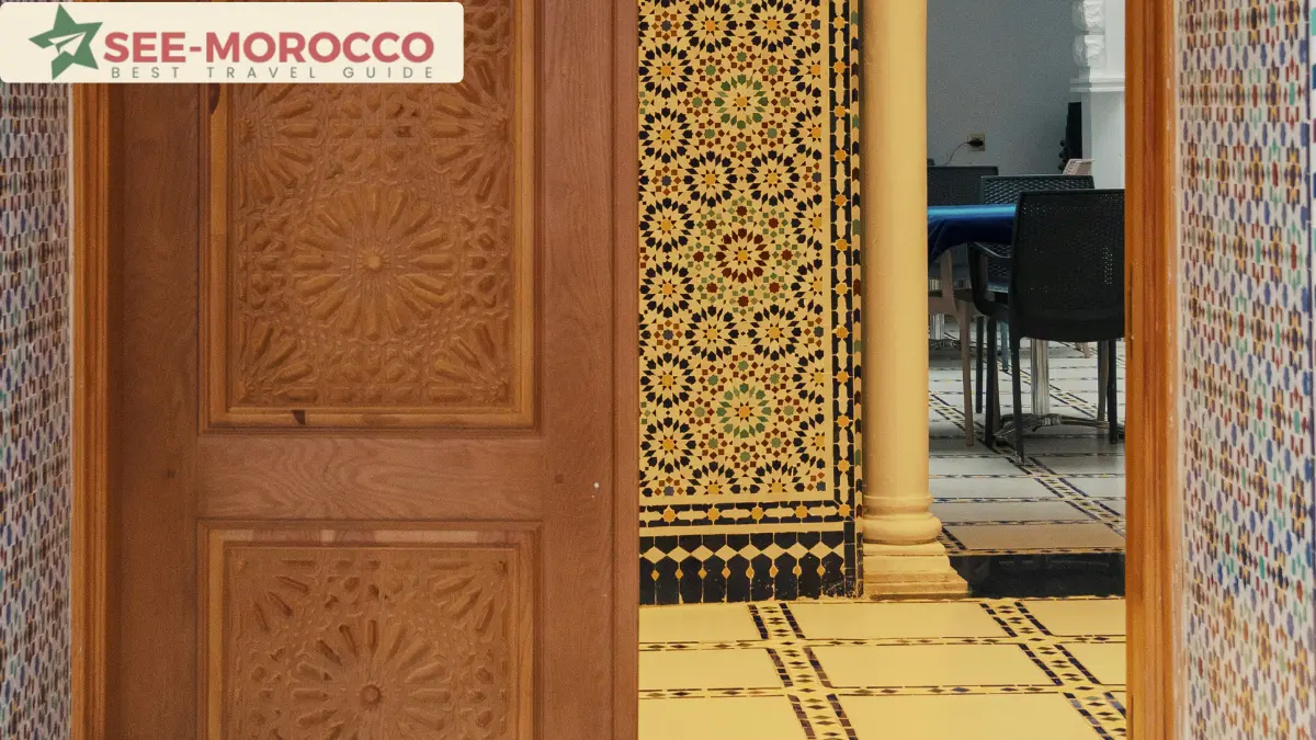 Moroccan riad interior zellige tilework carved cedar door Tangier boutique hotel