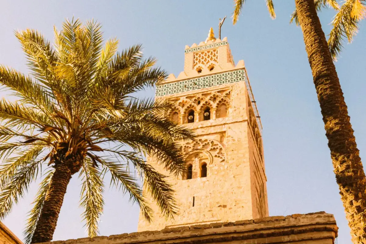 Morocco tours from Marrakech — Koutoubia Mosque minaret with palm trees