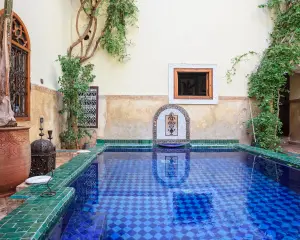 riad Marrakech courtyard pool with zellij tiles