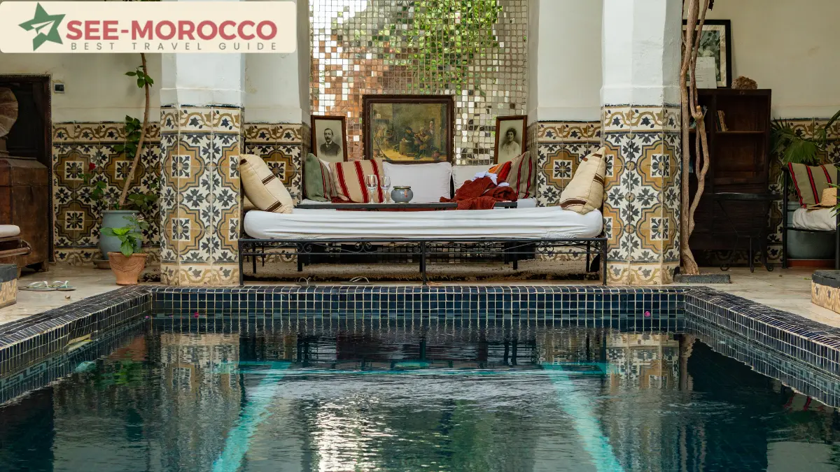 riad Marrakech courtyard pool with zellij tiles and traditional seating