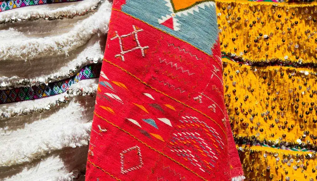 Berber rug Moroccan textile — traditional red white yellow handwoven fabrics with geometric symbols